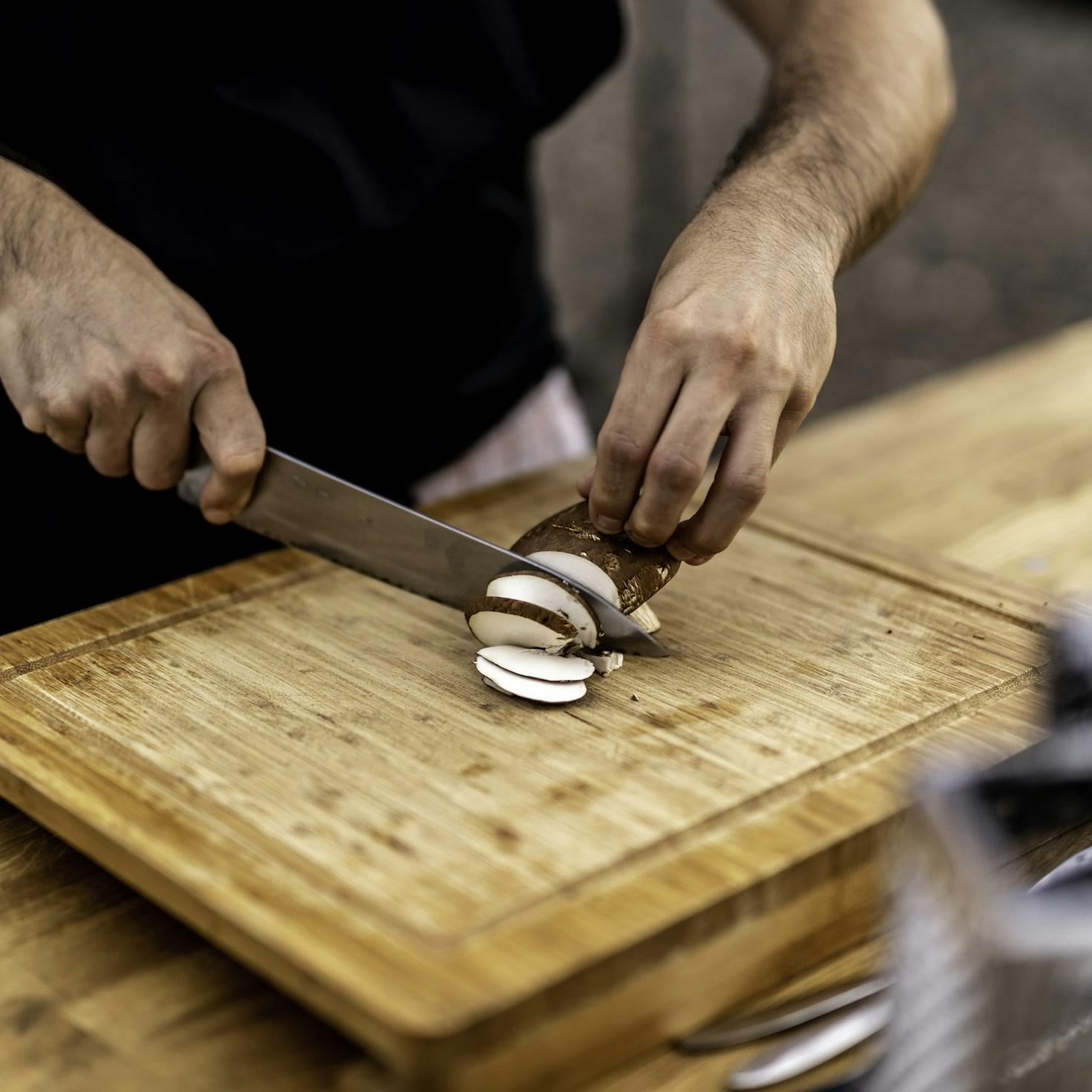 Diverse group of community members sharing a meal together, showcasing the social bonds formed through collaborative cooking